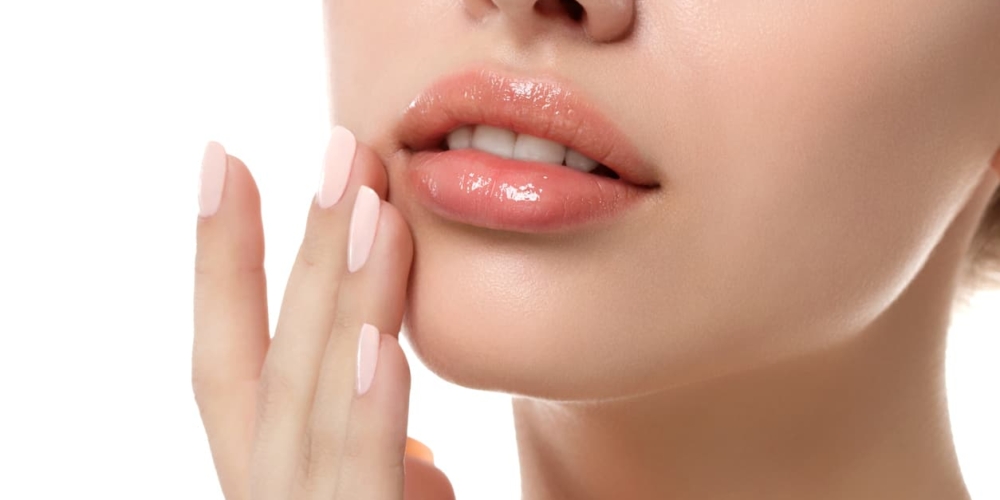 A womans face while touching her cheek