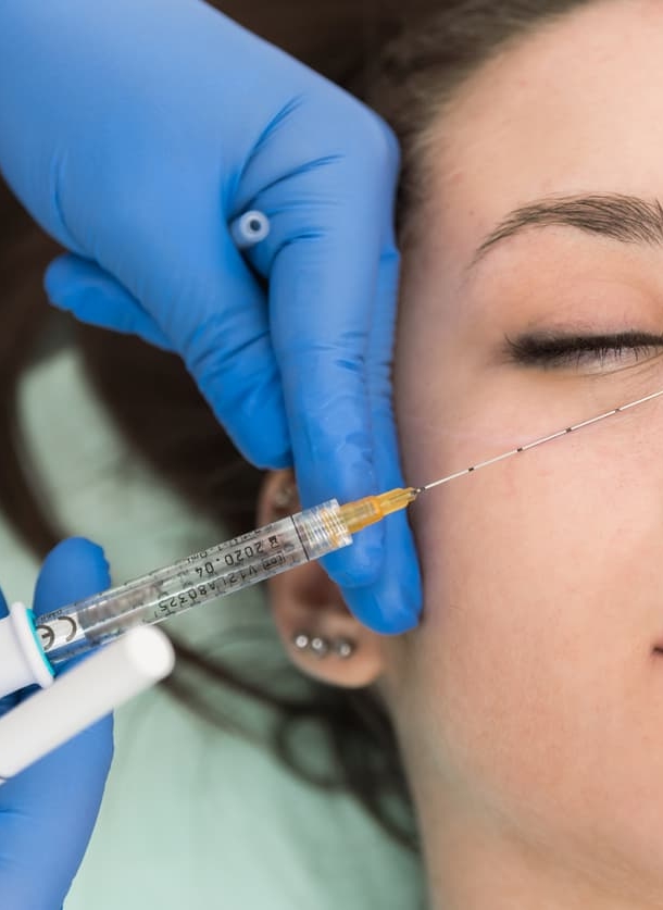 Patient undergoing dermal eye filler treatment