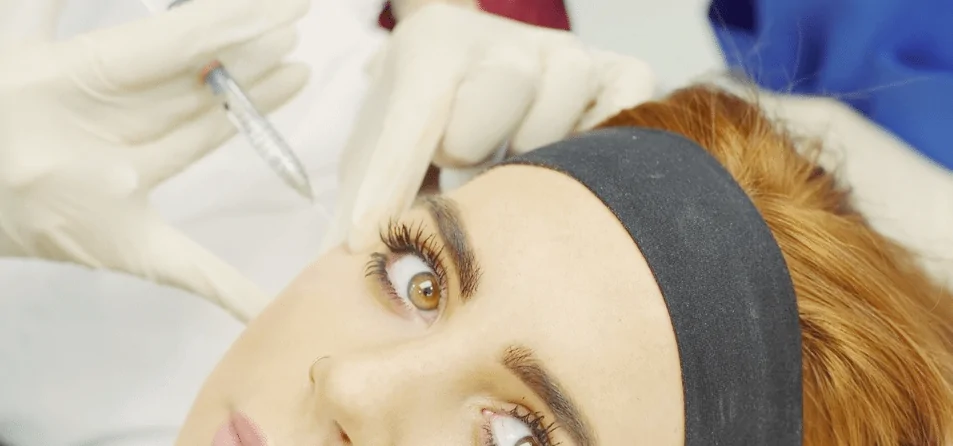 Close-up of provider administering Botox injections to the forehead area to smooth fine lines while the patient relaxes during treatment.